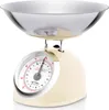 A retro-style analog kitchen scale with a cream-colored base and a silver bowl. Voir les images du produit