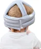 A baby wearing a protective helmet. Produktbild-Vorschau