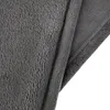 A close-up view of a folded grey plush blanket. Produktbild-Vorschau