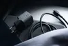 A black mobile device charger and cable are placed on a dark surface. Podgląd zdjęcia produktu
