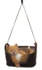 A decorative figurine of a sleeping orange cat in a brown basket, suspended by ropes. Produktbild-Vorschau