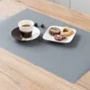 A placemat on a wooden table with a cup of coffee and cookies. Náhled obrázku produktu