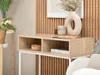 A console table with decorative items and plants in a room. Náhled obrázku produktu