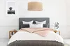 A bedroom scene with a bed, nightstands, and a hanging lamp. Produktbild-Vorschau