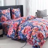 A bed with floral patterned bedding. Anteprima dell’immagine prodotto
