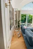 A living room with a blue sofa, a bookshelf, and a stepladder. Anteprima dell’immagine prodotto