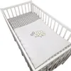 A baby crib with bedding inside. Náhled obrázku produktu