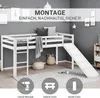 A white loft bed with a slide is shown in a room with gray walls and a patterned rug. Decorative baskets and pillows are placed around the bed. Náhľad obrázku produktu