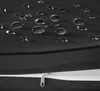 Close-up of a black fabric surface with water droplets and a zipper. Náhled obrázku produktu
