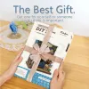 Hands holding a gift-wrapped DIY miniature bookshop kit. Náhled obrázku produktu