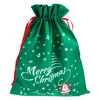 A green Christmas gift bag with red drawstrings and white Christmas-themed graphics. Produktbild-Vorschau