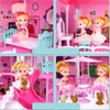 A collage of four images showing a pink dollhouse with dolls, furniture, and toy dogs. Voir les images du produit