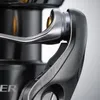 Close-up of a fishing reel handle and spool. Produktbild-Vorschau