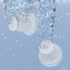 Two white vacuum cleaner attachments are submerged in swirling blue water, with small bubbles scattered around. Produktbild-Vorschau