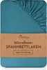A folded teal fitted sheet with a brown paper band around it. Produktbild-Vorschau