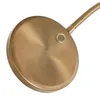 A close-up view of the base of a lamp, showing a circular bronze-colored plate with a small button and a flexible gooseneck arm extending from it. Anteprima dell’immagine prodotto