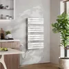 A modern kitchen or bathroom setting with a white electric towel warmer mounted on a textured gray wall, next to a large potted plant. Anteprima dell’immagine prodotto