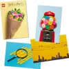 A collage of four different LEGO postcard images, featuring a bouquet of flowers, a gumball machine, a magnifying glass over LEGO bricks, and a city skyline with birds on power lines. Anteprima dell’immagine prodotto