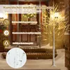 A decorative LED birch tree with warm white lights is placed outside a wooden door during winter, with snow on the ground. Anteprima dell’immagine prodotto