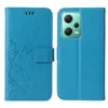 A blue flip cover phone case is shown open, revealing the inside and the back of a phone with a green camera module. Produktbild-Vorschau