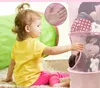 A young child is playing with a hanging toy organizer in a room. Produktbild-Vorschau