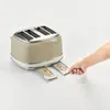 A hand is pulling out toast crumbs from a toaster. Produktbild-Vorschau
