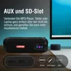 A black portable speaker is shown on a wooden surface, with text overlays describing its features and connection options. Produktbild-Vorschau