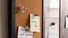 A close-up shot of a corkboard and a whiteboard with notes pinned to them. Podgląd zdjęcia produktu