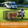 A woman interacting with a dog in a cage next to a camper van. Produktbild-Vorschau