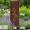 A decorative metal garden stake with a flower design, placed in a garden with lavender and other plants. Produktbild-Vorschau