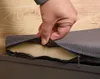 A hand is shown unzipping a cushion on a piece of furniture. Náhled obrázku produktu