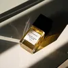 A bottle of Bohoboco Yellow Rose Incense perfume is placed on a white surface, with dramatic shadows cast across it. Produktbild-Vorschau