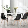 A dining set with four black chairs and a white table in a well-lit room. Náhled obrázku produktu