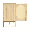 A light wood cabinet with one door open, revealing a rattan insert and a gold handle, set against a white background. Podgląd zdjęcia produktu