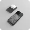 A black wireless charger with a white AirPod case on top, and a smartphone with a magnetic charger attached to its back. Náhled obrázku produktu