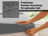 A person's hands are shown stretching a grey fitted sheet over a mattress. A close-up inset shows the elasticated edge of the sheet. Produktbild-Vorschau