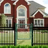 A dark green garden gate is shown in front of a large red brick house with a black metal fence. Produktbild-Vorschau