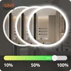 A circular LED mirror in a bathroom setting, with a slider indicating brightness levels. Náhled obrázku produktu