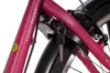 A close-up view of a pink bicycle frame with a black lock and key attached. Produktbild-Vorschau