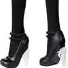 A close-up view of a doll's legs wearing black high-heeled shoes with clear, icy-looking heels. Náhľad obrázku produktu