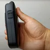 A hand holding a black electric shaver. Anteprima dell’immagine prodotto