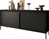 A black sideboard with fluted doors and drawers, decorated with various objects on top. Produktbild-Vorschau