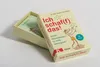 A box of cards is shown, with the lid partially open, revealing more cards inside. Voir les images du produit