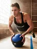 A man is doing a push-up exercise with a medicine ball in a gym. Náhľad obrázku produktu