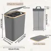 Diagram showing dimensions and features of a laundry basket. Voir les images du produit