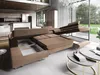 A modern living room with a large sectional sofa that has been converted into a bed, showing its storage and sleeping features. Produktbild-Vorschau
