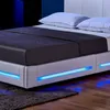 A close-up view of a modern white bed with a dark gray comforter and blue LED lighting along the base. Náhled obrázku produktu