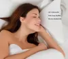 A woman is lying in bed, appearing to be comfortable and relaxed. Produktbild-Vorschau