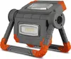A portable LED work light with a gray body and orange accents, shown on a white background. Produktbild-Vorschau
