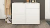 A white chest of drawers with a coat and boots nearby, suggesting an entryway or hallway setting. Produktbild-Vorschau